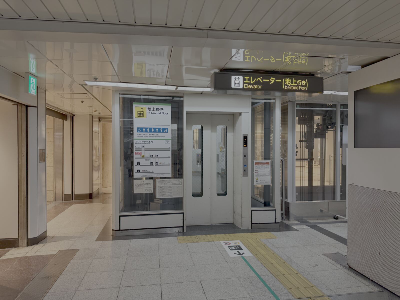 Glass-walled street-level subway elevator kiosk at Nagoya Station's Central Gate, a second angle.
