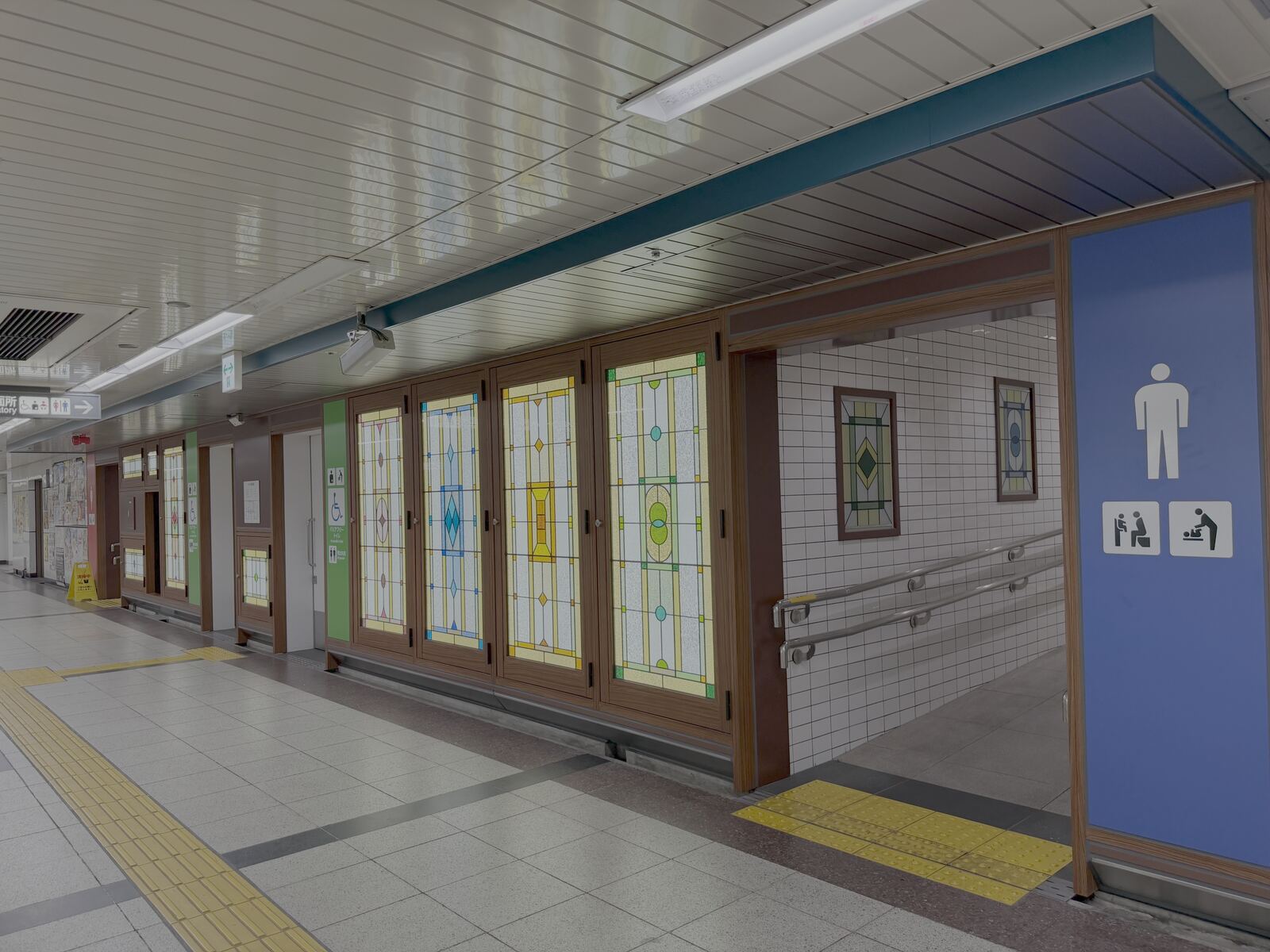 Corridor with stained-glass panels leading to the toilets near the subway concourse at Nagoya Station.