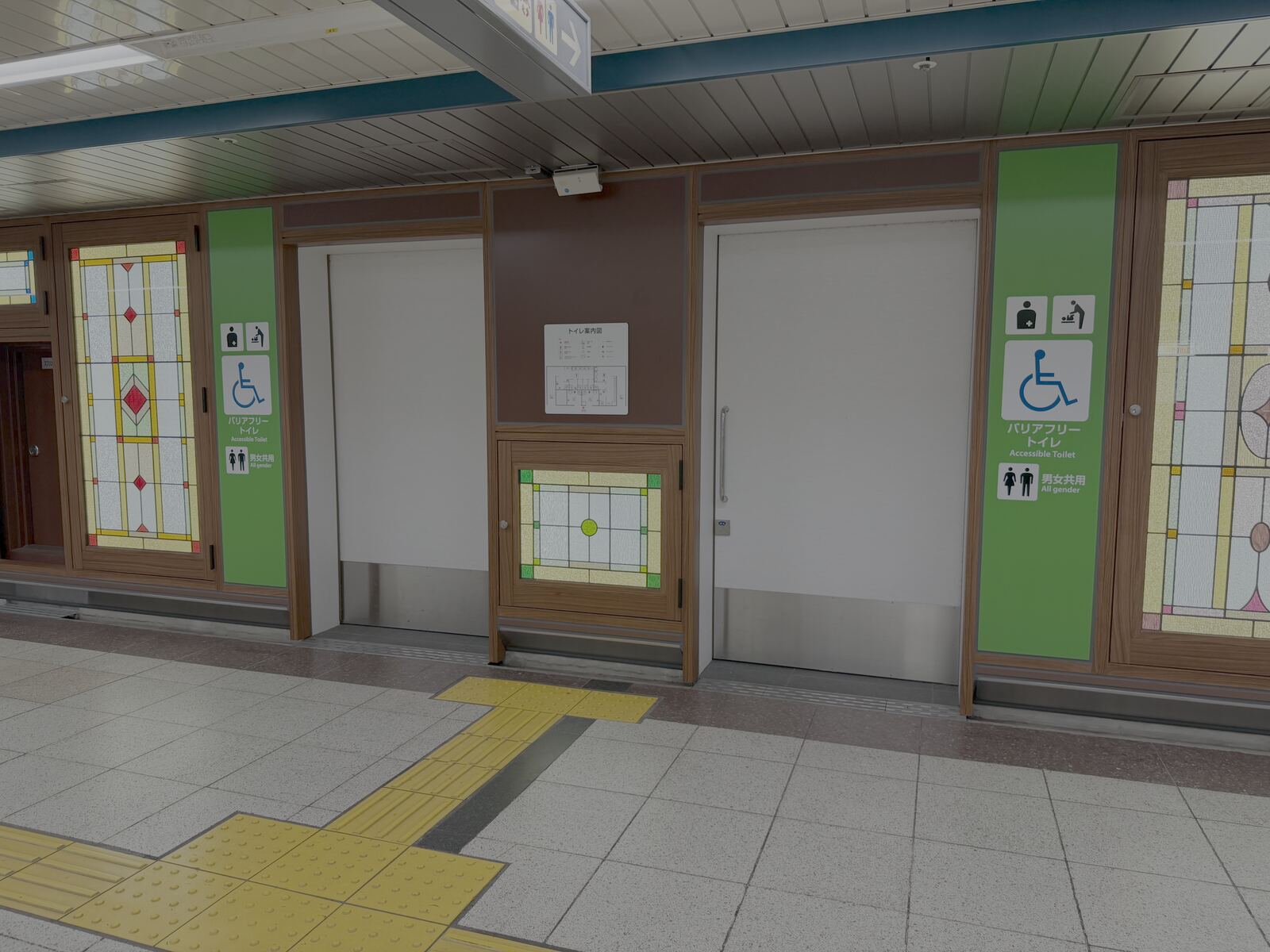 Corridor with stained-glass panels leading to the toilets near the subway concourse at Nagoya Station, a second angle.