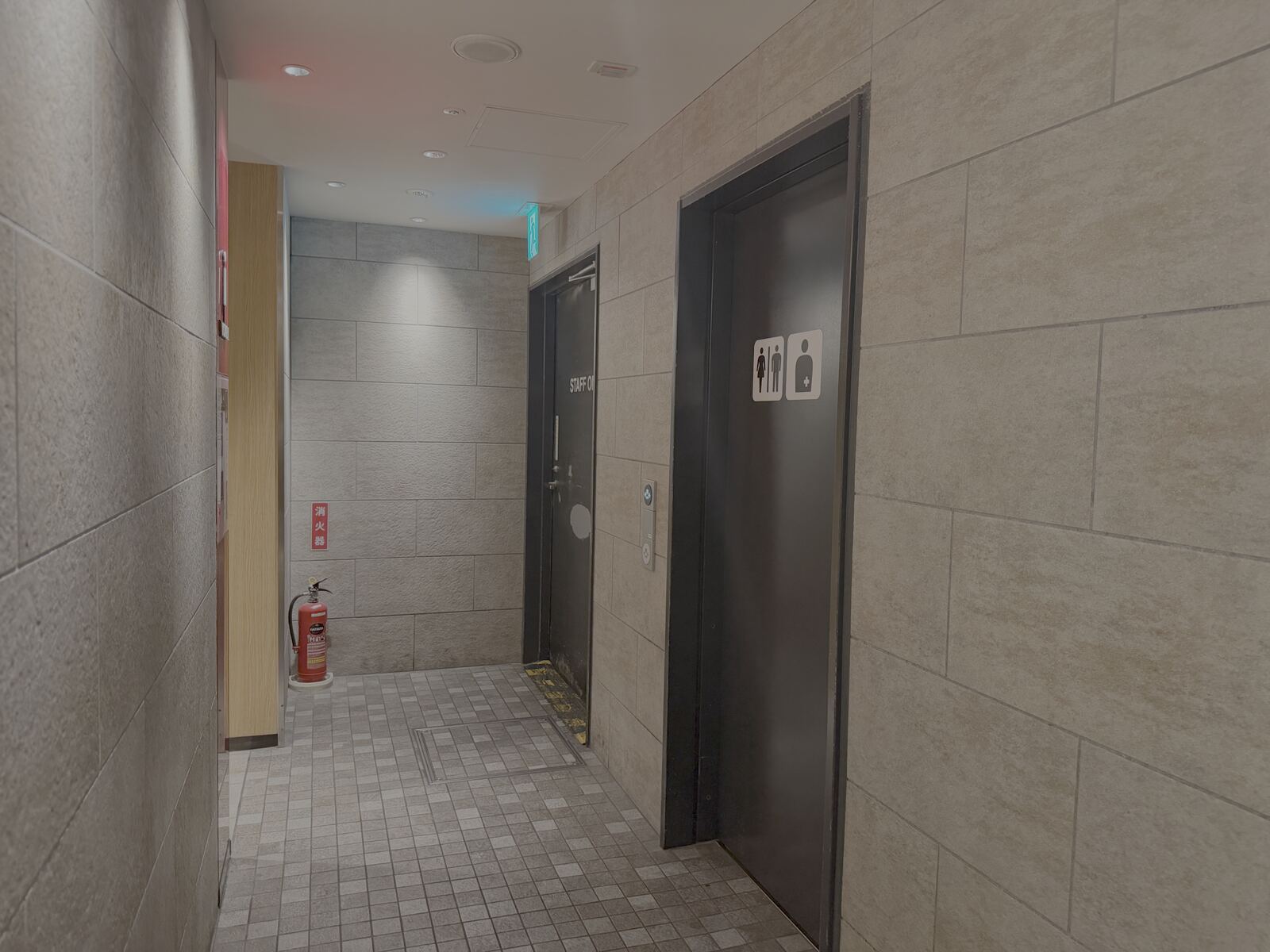 Accessible toilet with wheelchair, baby-seat and ostomate pictograms on Umaimon Street, near the Taikodori side of Nagoya Station, a second angle.